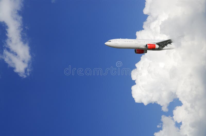 Airplane emerging from out of cloud