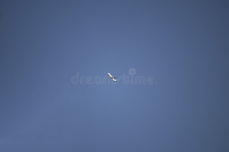 AN airplane is flying from east to west. The sky is perfectly blue. A airplane is flying from east to west. The sky is perfectly blue royalty free stock photos AN airplane is flying from east to west. The sky is perfectly blue. A airplane is flying from east to west. The sky is perfectly blue royalty free stock photos