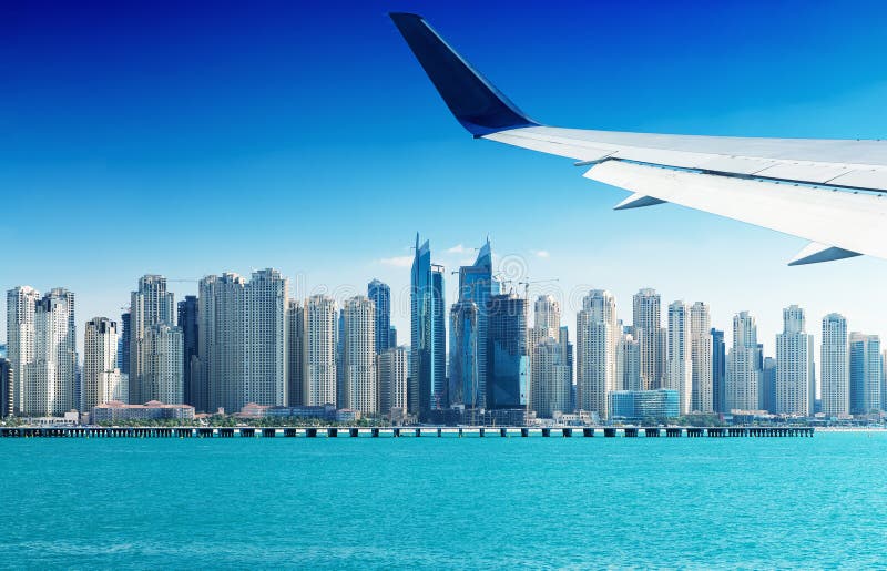 Airplane Flying Over Dubai Skyscrapers, UAE Stock Photo Image of