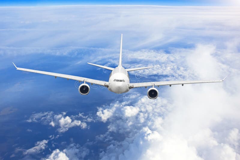 Airplane is Gaining Altitude Flying Out of Dense Clouds. Stock Photo