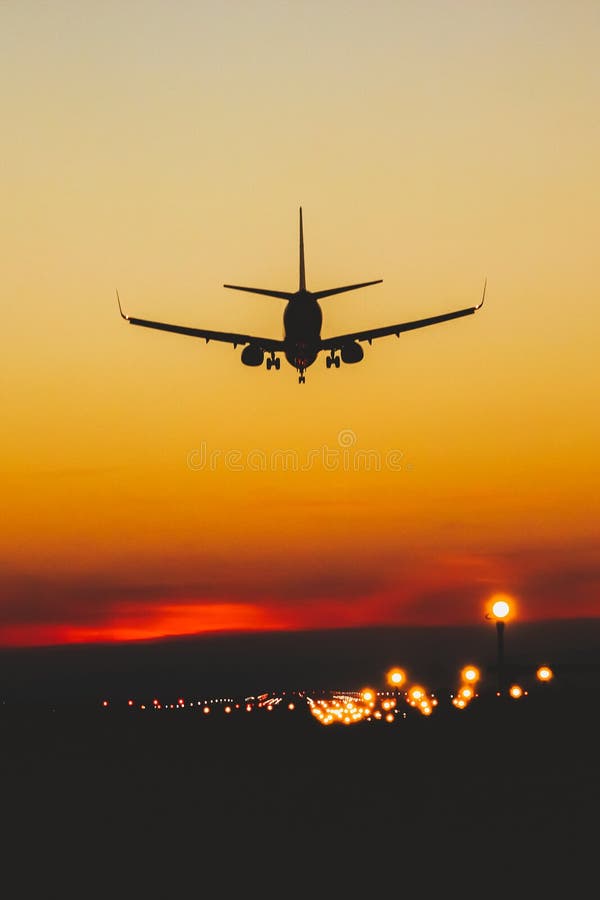 Airplane Landing on the Runway during Sunset and Night Stock Image - Image  of airplane, commercial: 228335849