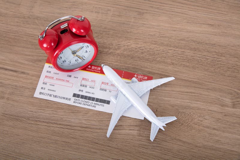 Airplane Model and Boarding Pass and an Alarm Clock Stock Photo Image