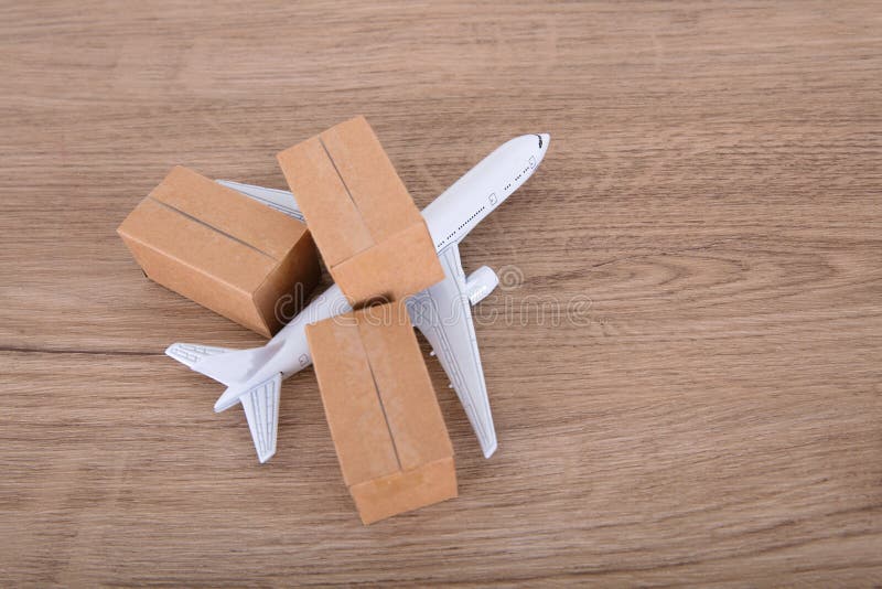 An Airplane Model and a Courier Shipping Box Model on the Table Stock