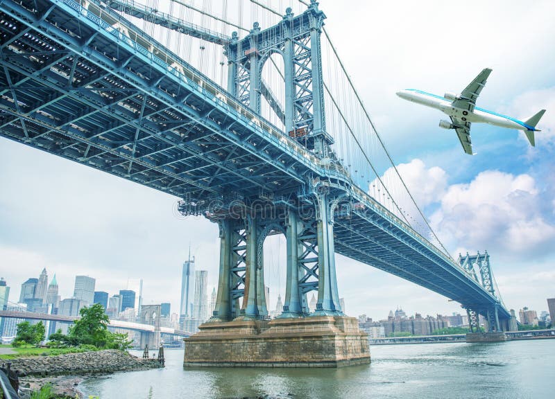 Airplane Overflying New York and Manhattan Bridge Stock Image Image