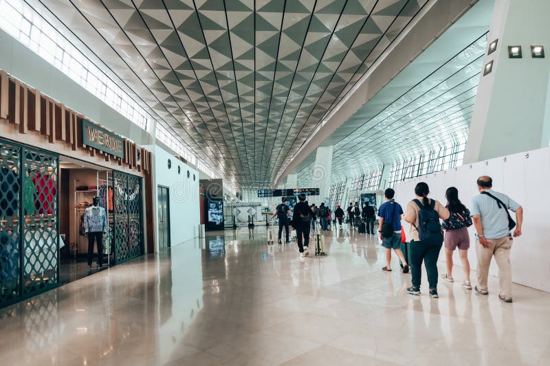 Airplane passengers are walking through Terminal 3 of Soekarno-Hatta Airport to get to the gates. Airplane passengers are walking through Terminal 3 of Soekarno-Hatta Airport to get to the gates.