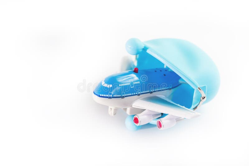 Toy airplane peeking out of a blue purse isolated. budget, expensive airlines or saving for travel concept