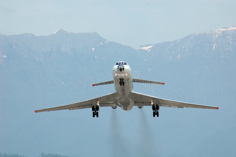 Airplane at takeoff on mountain background