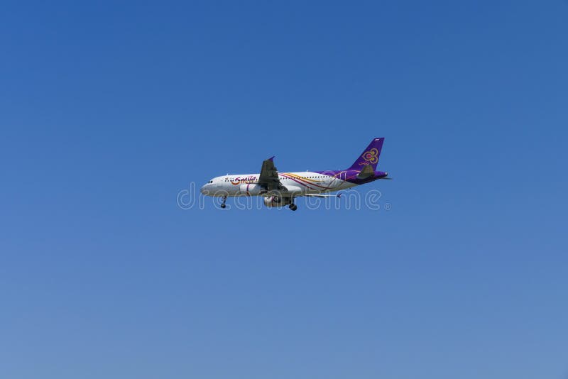 The Airplane Of Thai Smile Air Is Flying In Blue Sky
