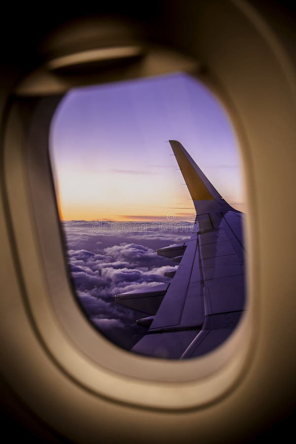 Airplane window overlooking the clouds and skyline of Valencia Spain