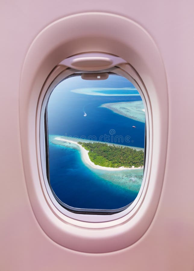 Airplane window view of Maldives islands