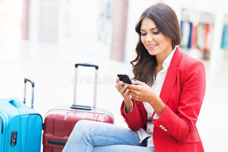 Airport business woman on smart phone at gate