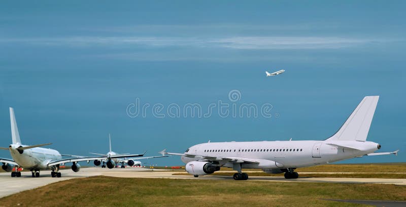 Busy airport, airplanes  in runway queue