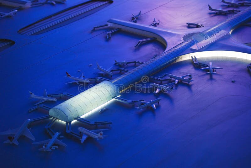 Airport terminal and docked jets at night in Shanghai, China.