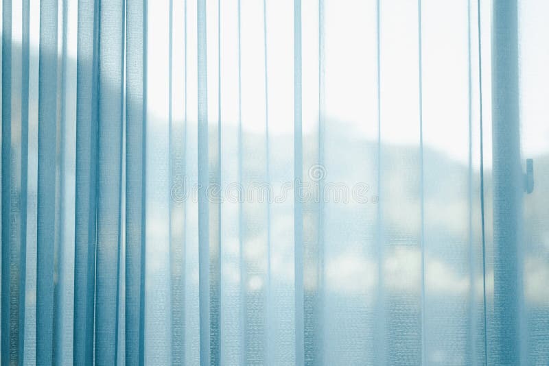 Airy transparent blue sheer curtain for see through and soft light on balcony window and close in room for home