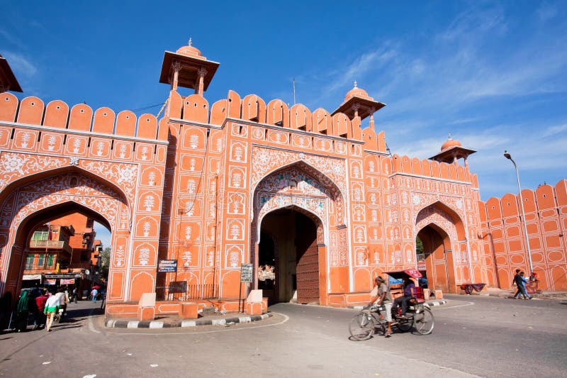 JAIPUR, INDIA: Ajmer gate of historical Pink City wall and moving cyclist under blue sky. Jaipur, with population 6,664,000 people, is a capital of Rajasthan