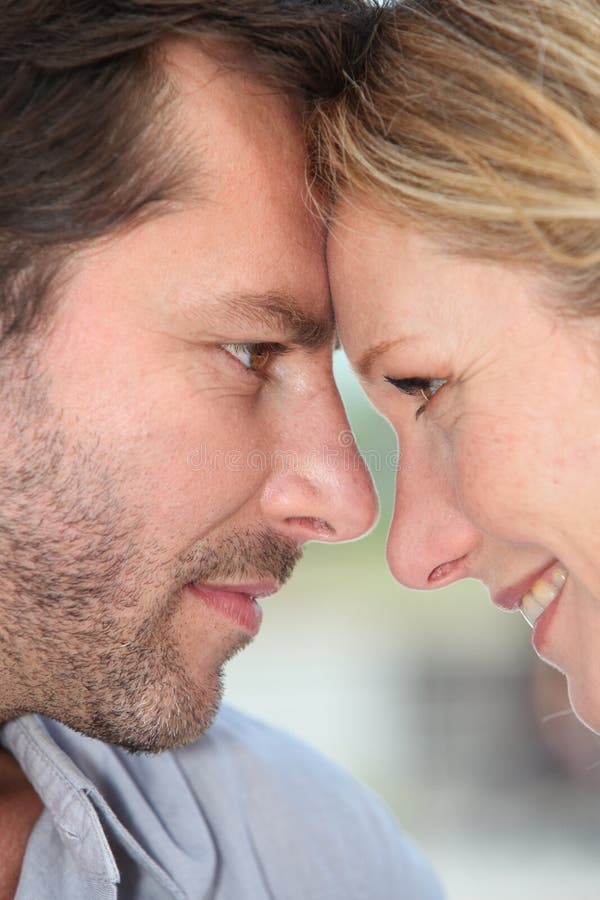 Couple facing each other with their heads together. Couple facing each other with their heads together