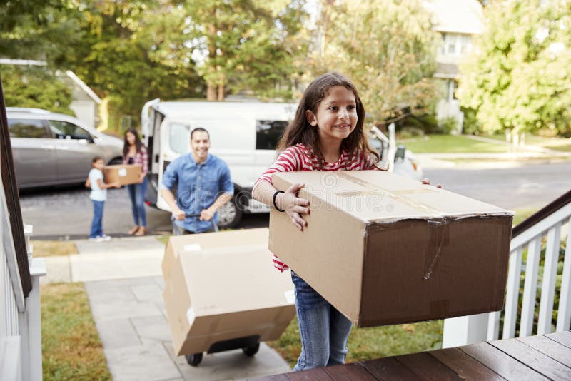 A ajuda das crianças descarrega caixas do dia de Van On Family Moving In