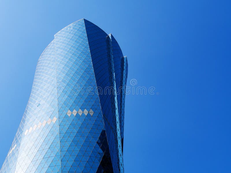 Al Bidda Tower contra o céu azul claro, fim acima Arranha-céus moderno com fachada vitrificada imagem de stock royalty free Al Bidda Tower contra o céu azul claro, fim acima Arranha-céus moderno com fachada vitrificada imagem de stock royalty free