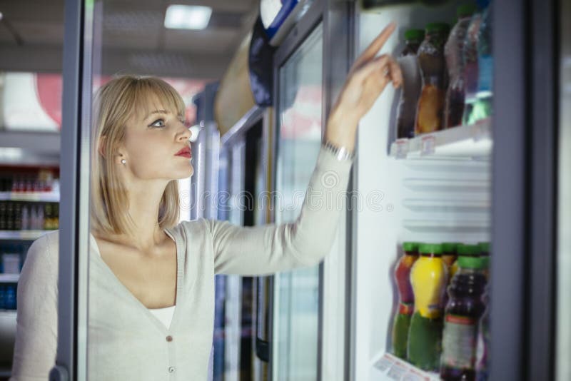 Female Buying Groceries At Supermarket. Female Buying Groceries At Supermarket