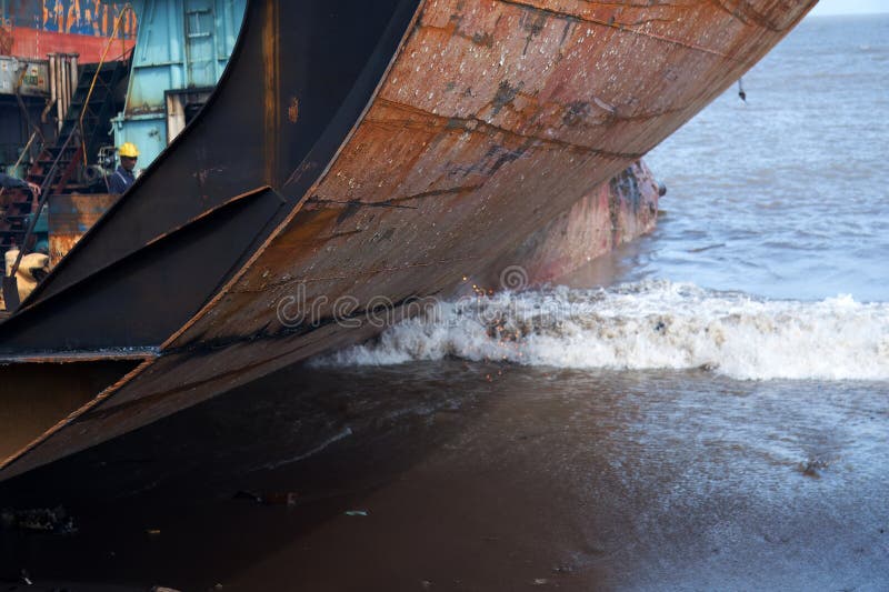 Alang, Bhavnagar, 31, August, 2024: A large section of a ship descends into Ocean water at Alang Shipyard, showcasing the process royalty free stock photography