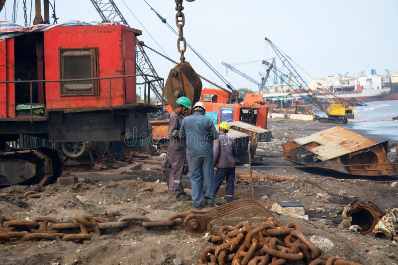 Alang, Bhavnagar, 31, August, 2024: A worker supervising the operations of a heavy-duty crane at Alang, highlighting the scale and royalty free stock photo
