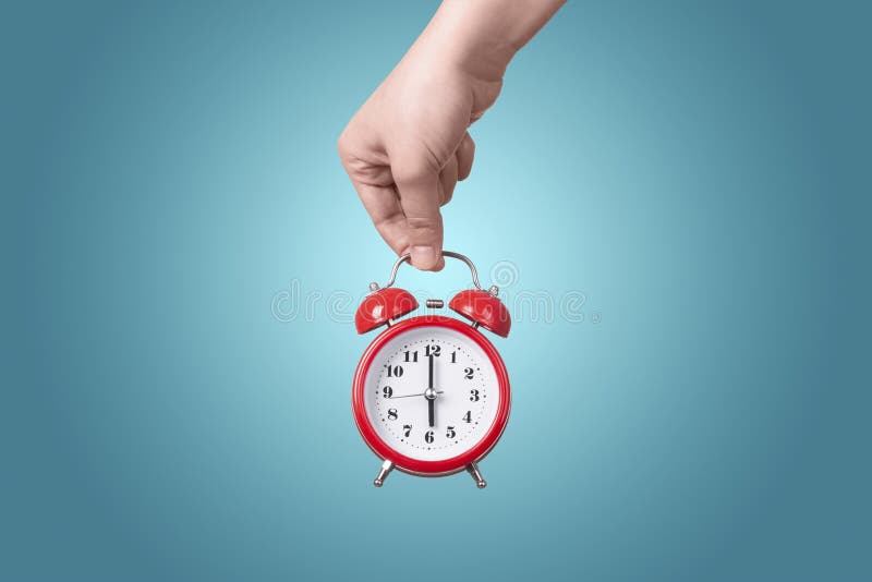 Alarm clock in hand stock image. Image of start, sound 146583773