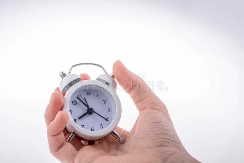 Alarm clock in hand stock image. Image of conceptional 125695115