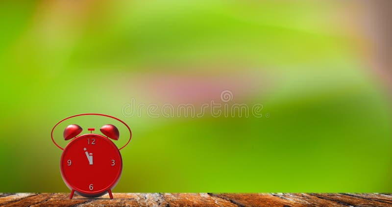 Alarm clock with little minutes to twelve o`clock stock photos