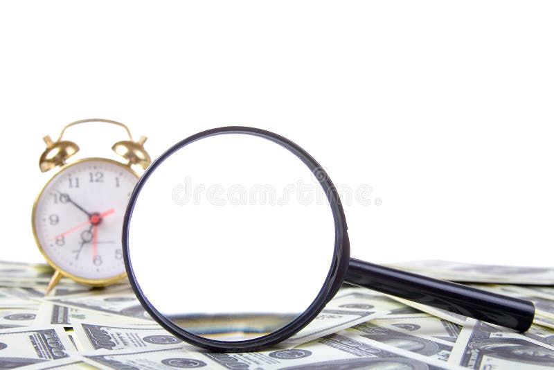 Alarm clock and loupe on a stack of dollars