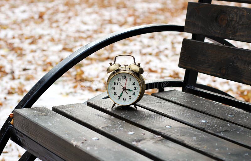 Alarm clock on natural landscape season park