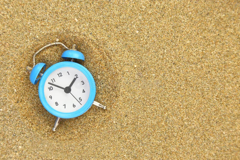 Alarm clock on the sand