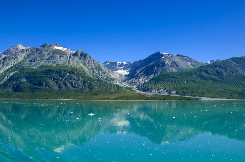 Alaska landscape mountains and water and blue sky. Mountains reflection in the water. Remote location, unplugged. Wild