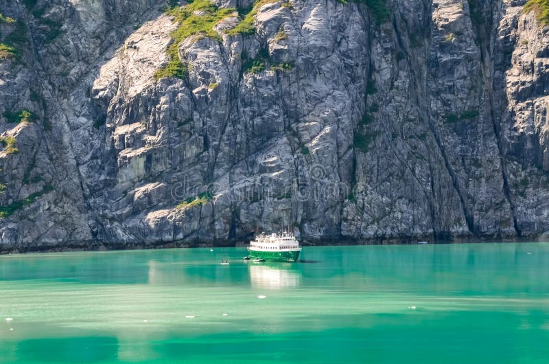 Alaska landscape mountains and water with the boat. Mountains reflection in the water. Remote location, unplugged. Wild