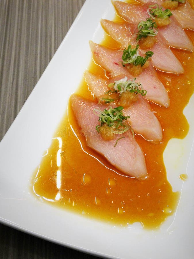 Fresh thin sliced albacore with crispy onion and oily brown sauce. Fresh thin sliced albacore with crispy onion and oily brown sauce