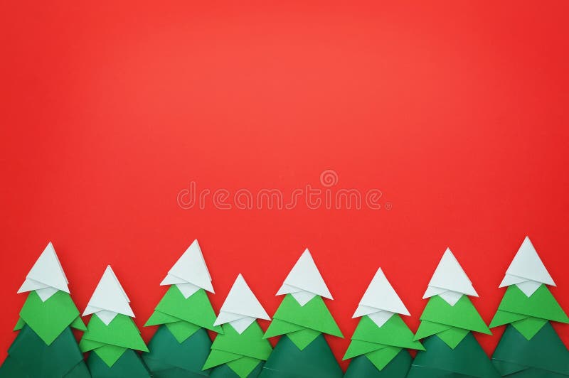 Handmade origami paper craft Christmas tree on red paper. Photo take on 2017. Handmade origami paper craft Christmas tree on red paper. Photo take on 2017