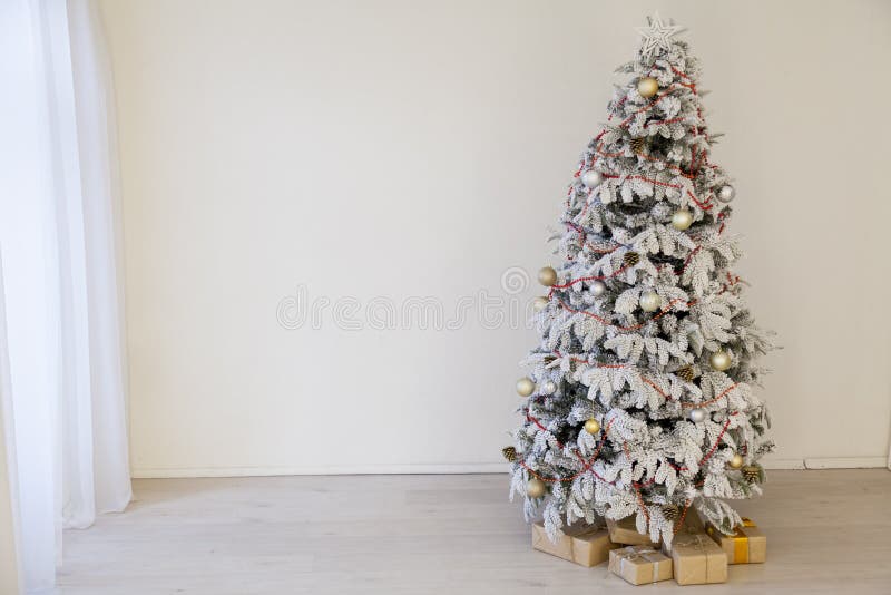 Christmas snowy Christmas tree with presents in a white room in winter 1. Christmas snowy Christmas tree with presents in a white room in winter 1