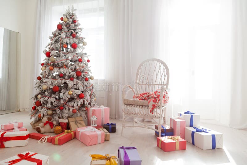 Christmas snowy Christmas tree with presents in a white room in winter 1. Christmas snowy Christmas tree with presents in a white room in winter 1