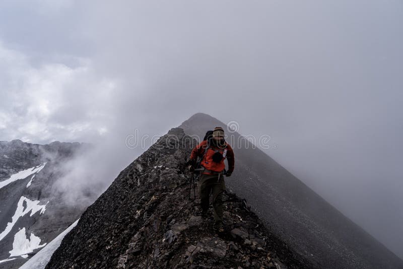 A hiker in the mountains of Peter Lougheed Provincial Park. Kananaskis Lakes, Alberta. Canada