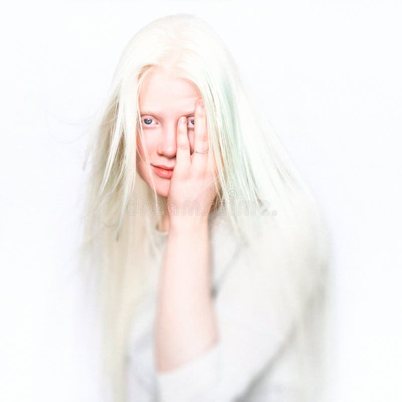 Albino female with white skin, rose lips and white hair. Photo face on a light background. Portrait of the head. Blonde girl