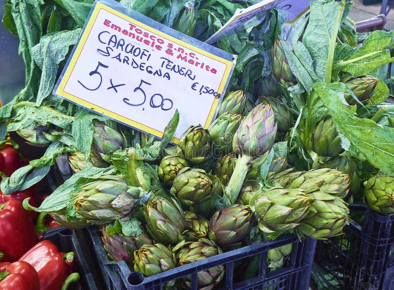 Turin, Italy - December 30, 2018. A box of fresh Sardinian spiny artichokes in a market with a cartel in Italian showing the price. Turin, Italy - December 30, 2018. A box of fresh Sardinian spiny artichokes in a market with a cartel in Italian showing the price