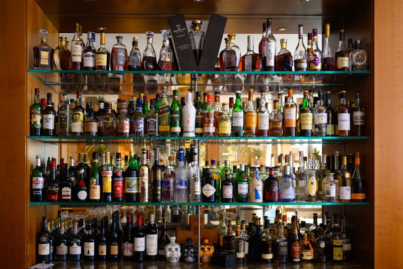 Well stocked bar with various alcoholic bottles and glasses