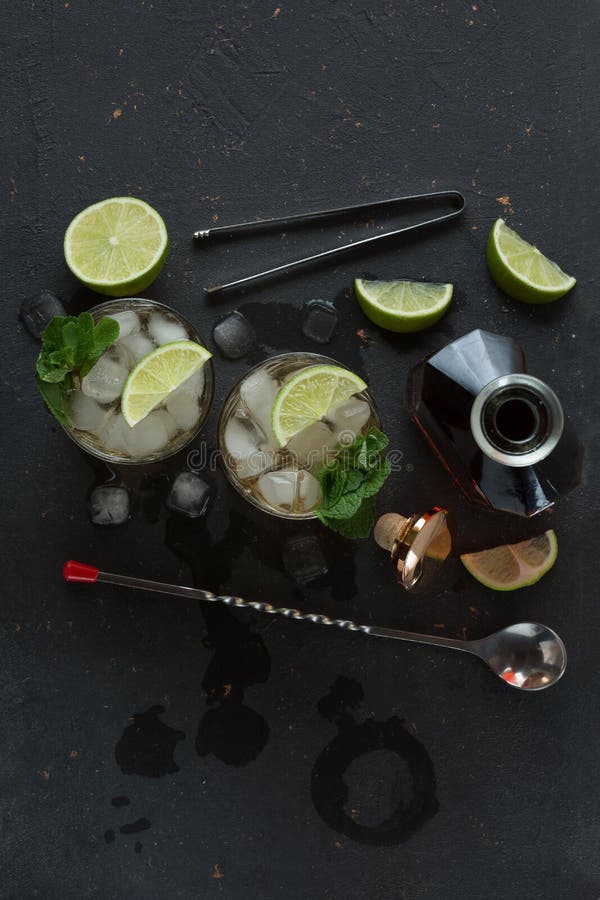 Alcoholic Cocktail with Rum and Ice and Mint on a Dark Background in a