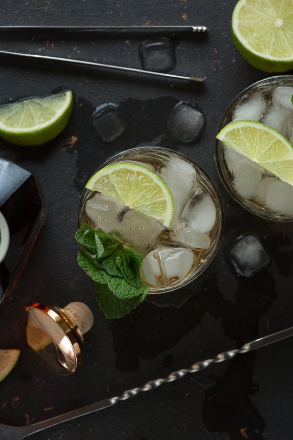 Alcoholic Cocktail with Rum and Ice and Mint on a Dark Background in a