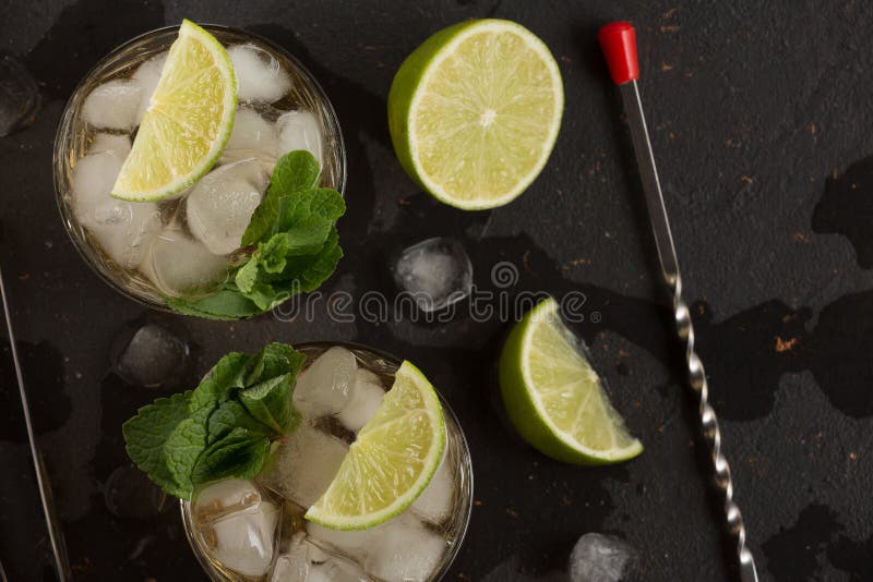 Alcoholic Cocktail with Rum and Ice and Mint on a Dark Background in a