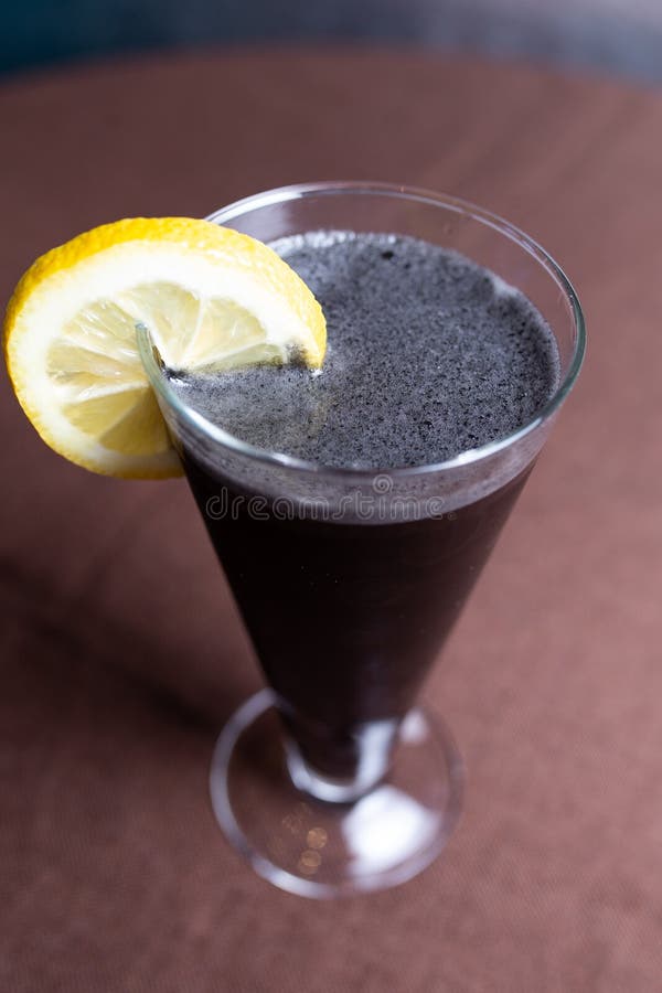 Alcoholic Drink with CocaCola and a Slice of Lemon in a Glass Stock