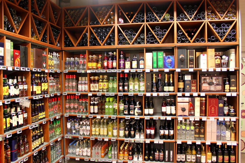 A big alcohol store with huge collection of alcohols, wines or other drinks.Wine rack in the supermarket. A big alcohol store with huge collection of alcohols, wines or other drinks.Wine rack in the supermarket.