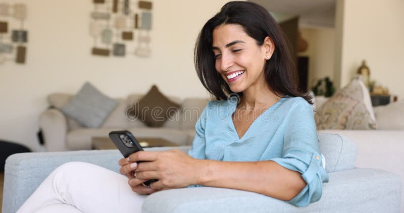 Alegre hermosa joven hispana usuaria de celulares navegando por Internet metrajes
