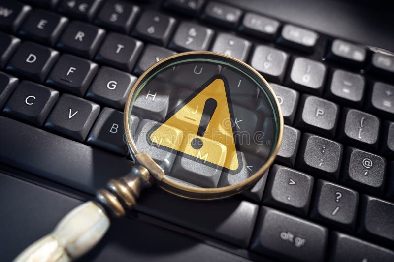 Alert warning notification on computer keyboard in magnifying glass for network security, virus or privacy error stock images