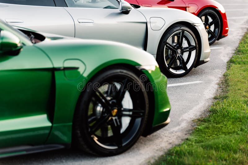 Alesund, Norway - May 31, 2020- luxury electric german sedans Porsche Taycan photographed during sunset. 3 cars in a row