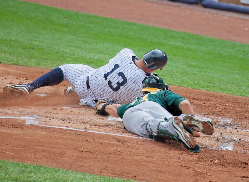 Alex Rodriguez of baseball's New York Yankees slides safely past the Oakland Athletics catcher George Kottaras in a close play at home plate. Alex Rodriguez of baseball's New York Yankees slides safely past the Oakland Athletics catcher George Kottaras in a close play at home plate.